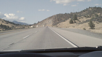 Photo of a dessert road through the windshield